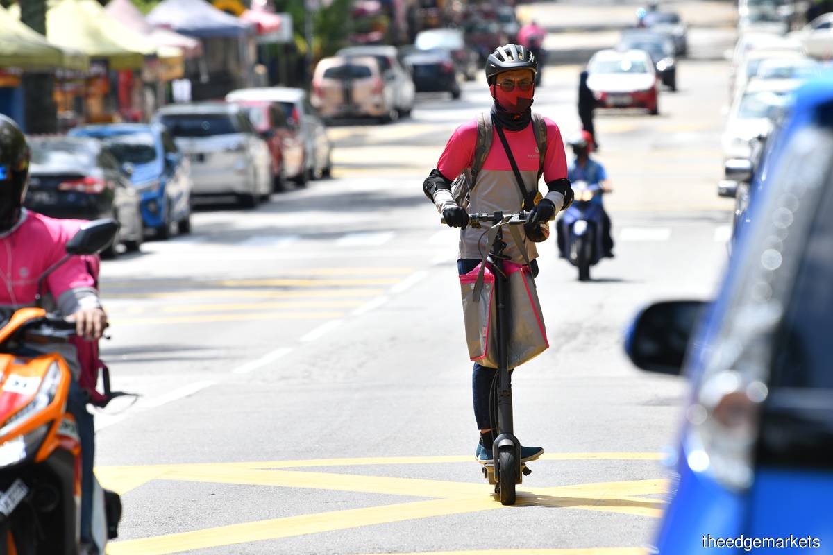 'Grab Malaysia and foodpanda are the first among the 133 service providers to enrol their delivery partners under SOCSO's Occupational Disaster Scheme,' says Tengku Zafrul. (Photo by Mohd Suhaimi Mohamed Yusuf/The Edge)